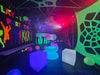 Lay-z-days Event's 3x4.5m UV glow party tent set up for outdoor celebration, featuring vibrant lighting and spacious design.