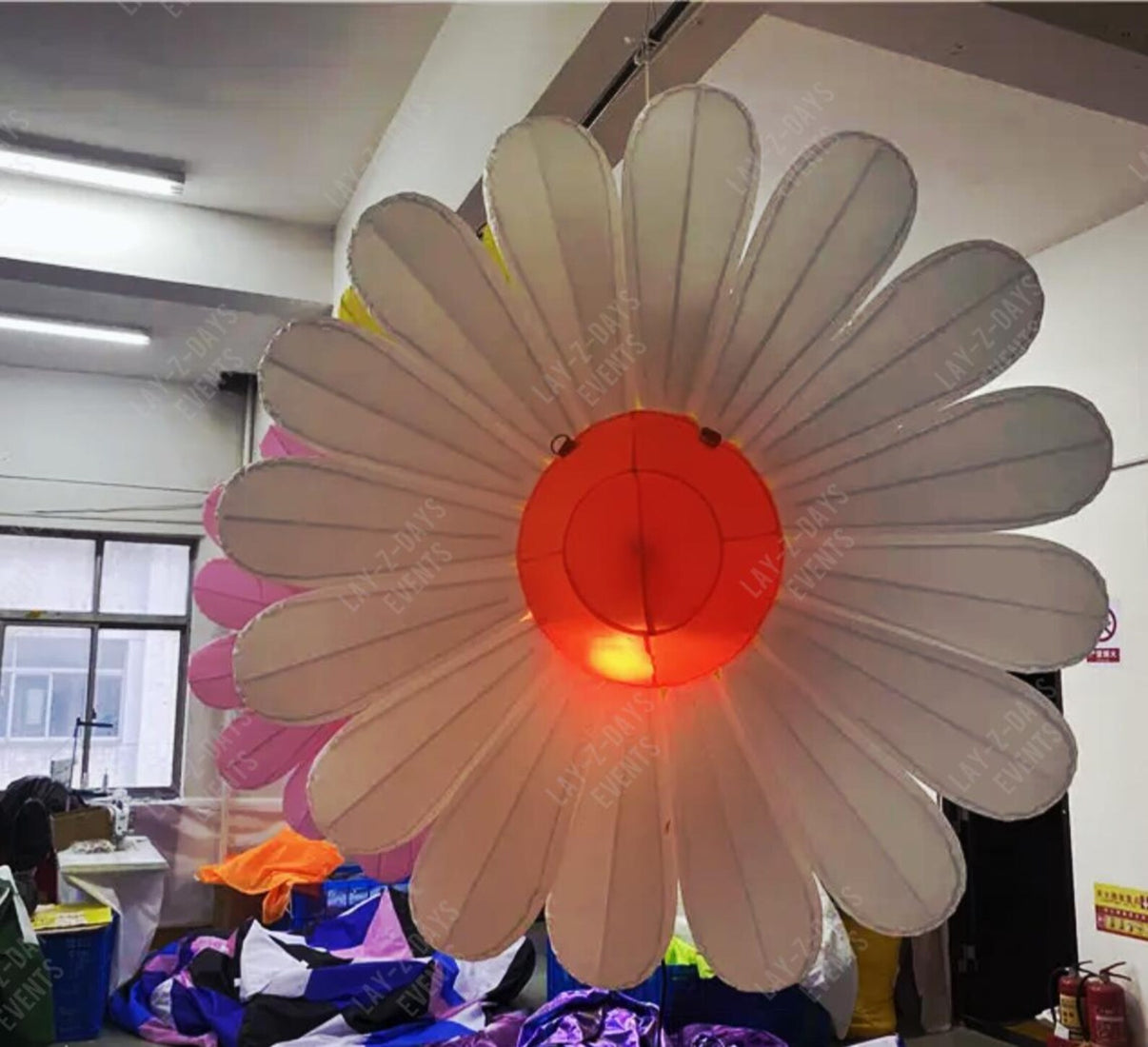 Large LED inflatable flower decoration by Lay-z-days Event's™, illuminated outdoor event decor with bright, colorful lighting.