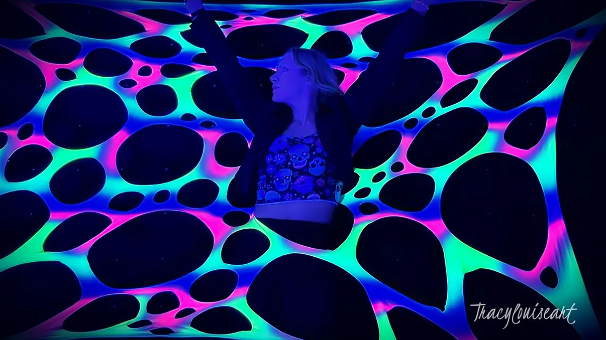 Colorful UV Rainbow Stretch Webbing for party decor, glowing under blacklight, by Lay-z-days Event's™ for vibrant neon blacklight parties.